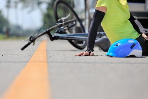 Female Cyclist Laying In The Road After Being Hit By A Car
