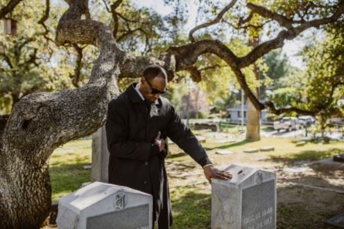 Man At A Cemetary Grieving The Death Of A Loved One