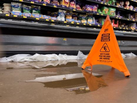 puddle of water in grocery store aisle