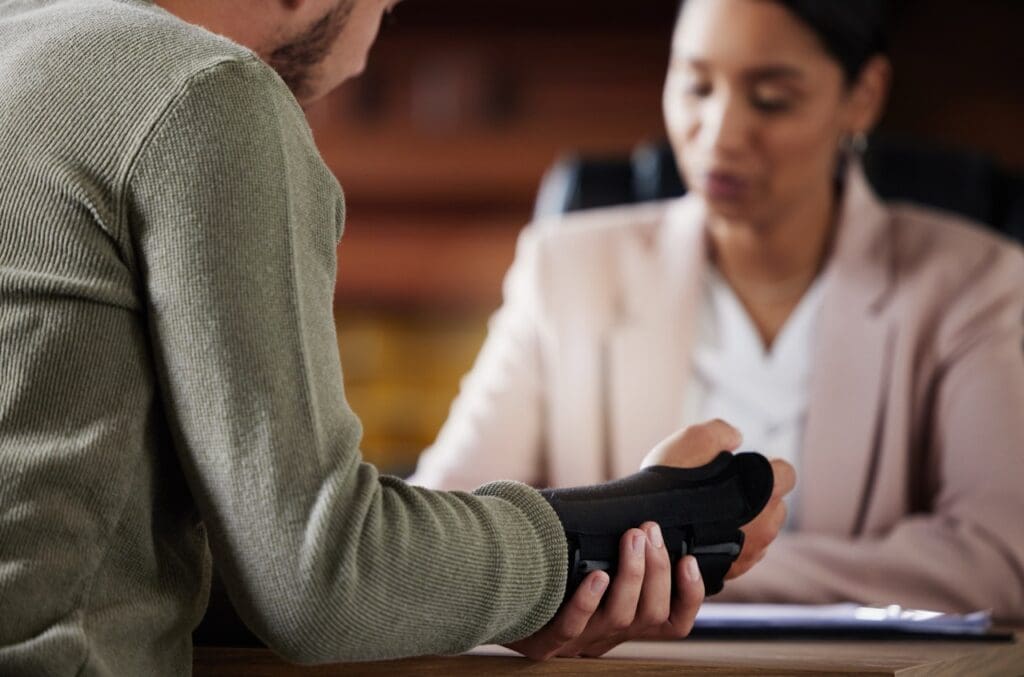 Person with hand injury talking to personal injury lawyer