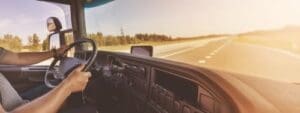 Charlotte Hit and Run Accident Lawyer - Payne Law Firm truck driver gripping steering wheel inside cab on open highway