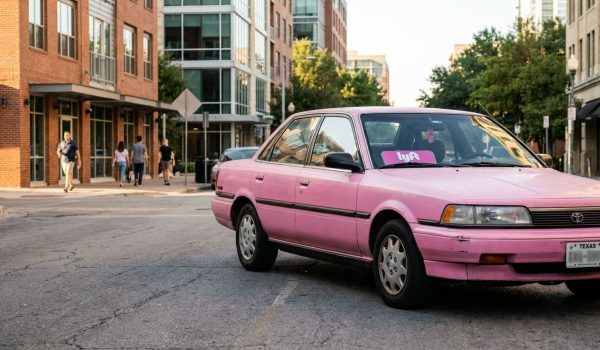 Lyft-branded Toyota sedan with Texas license plate parked on urban street